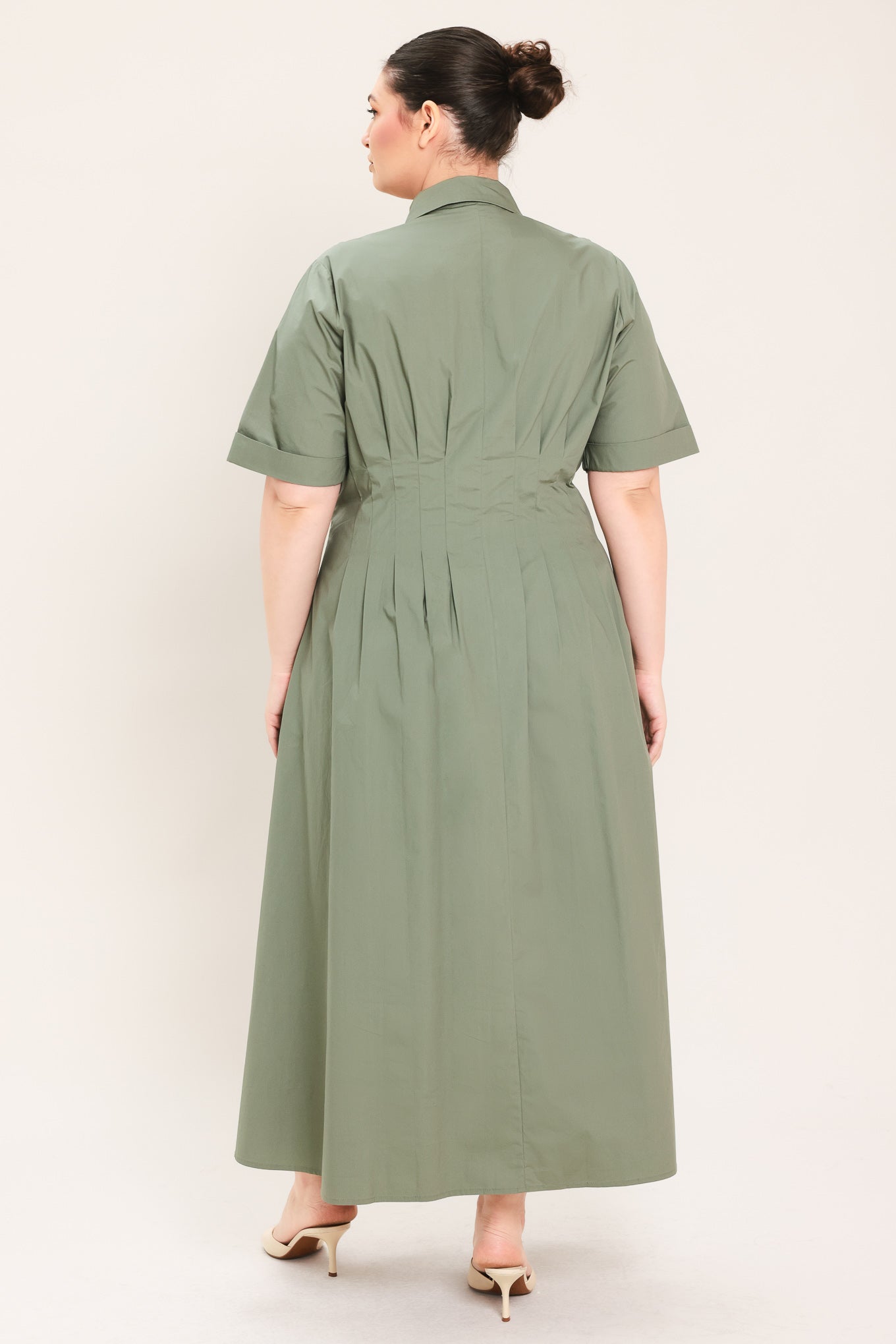 A woman modeling a olive green midi shirt dress with short sleeves, a button-down front, and a gathered waist | Plus Curve Flying Tomato