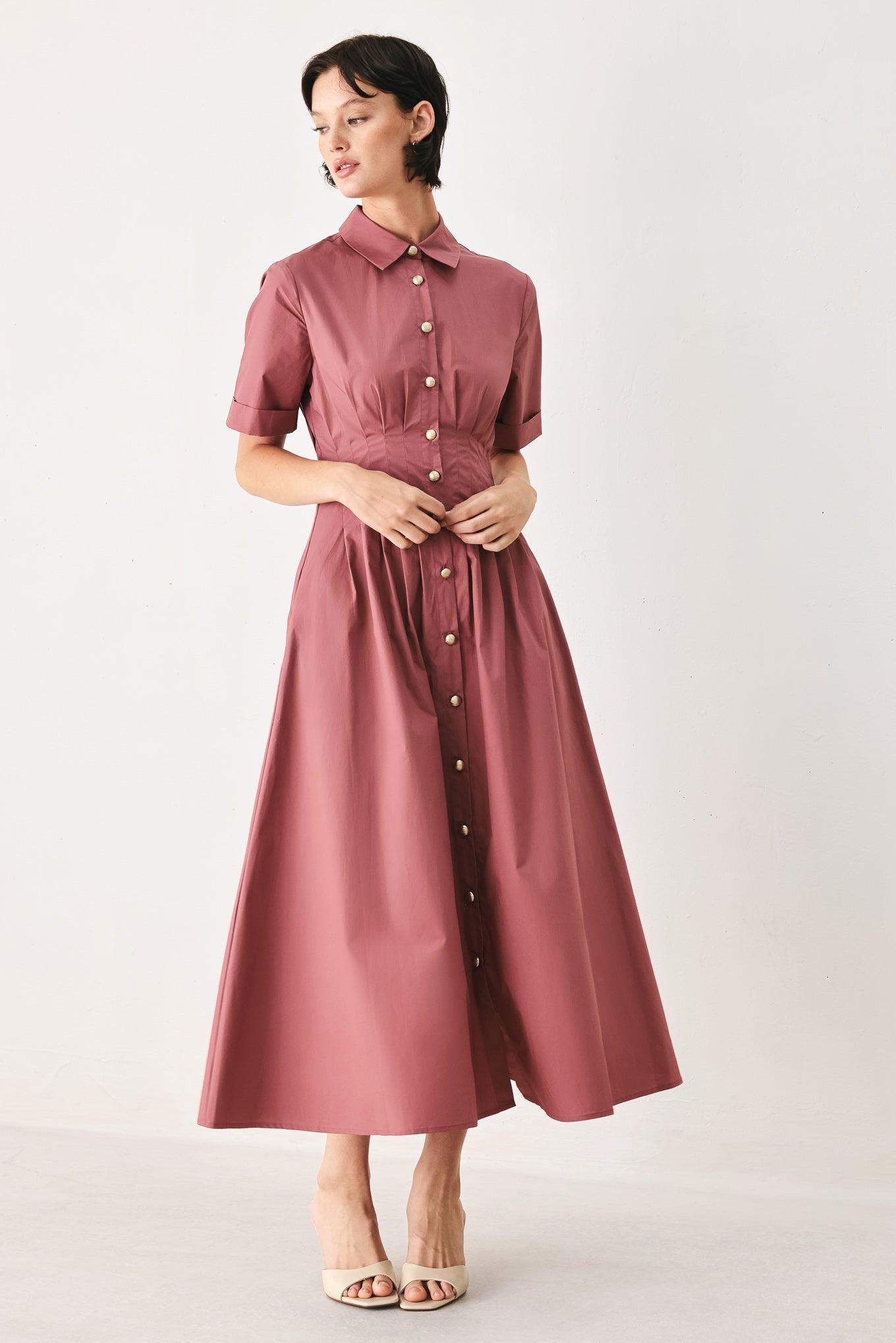 Woman wearing a mauve pink midi dress featuring collar, short sleeve, button down, corset waist, side pockets and full skirt | FREEMARKET