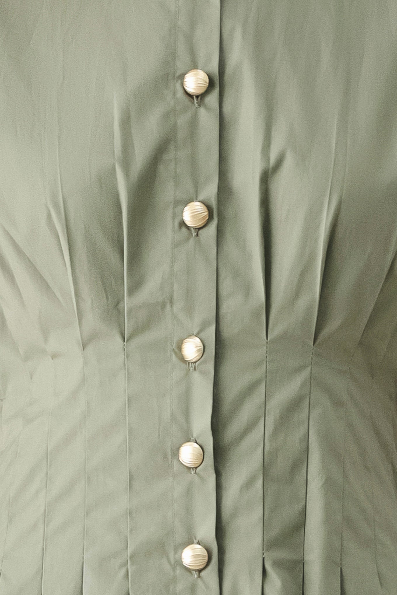 Woman wearing an olive midi dress featuring collar, short sleeve, button down, corset waist, side pockets and full skirt | FREEMARKET