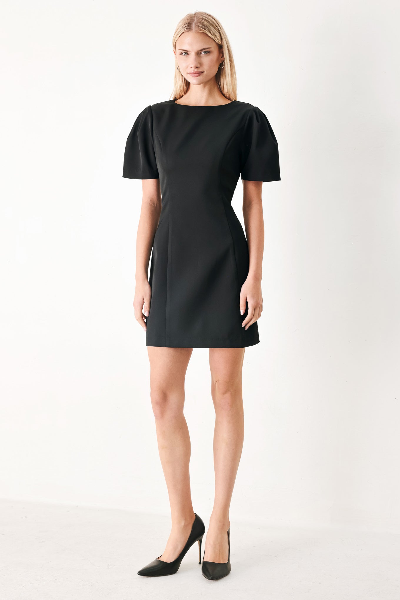 Woman wearing a black mini dress featuring round neckline, short sleeve and back zipper closure | FREEMARKET