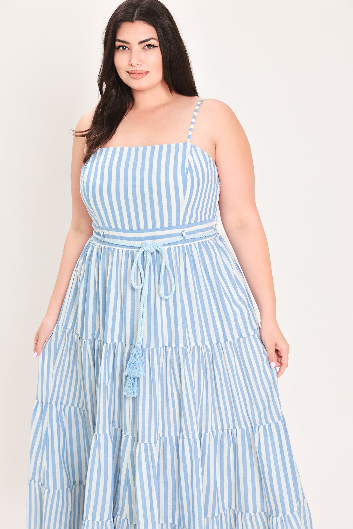 Woman wearing a blue and white striped maxi dress with a self tie belt | Flying Tomato Curve