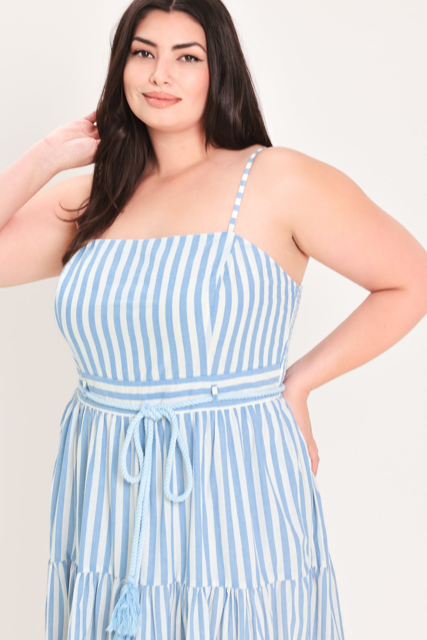 Woman wearing a blue and white striped maxi dress with a self tie belt | Flying Tomato Curve