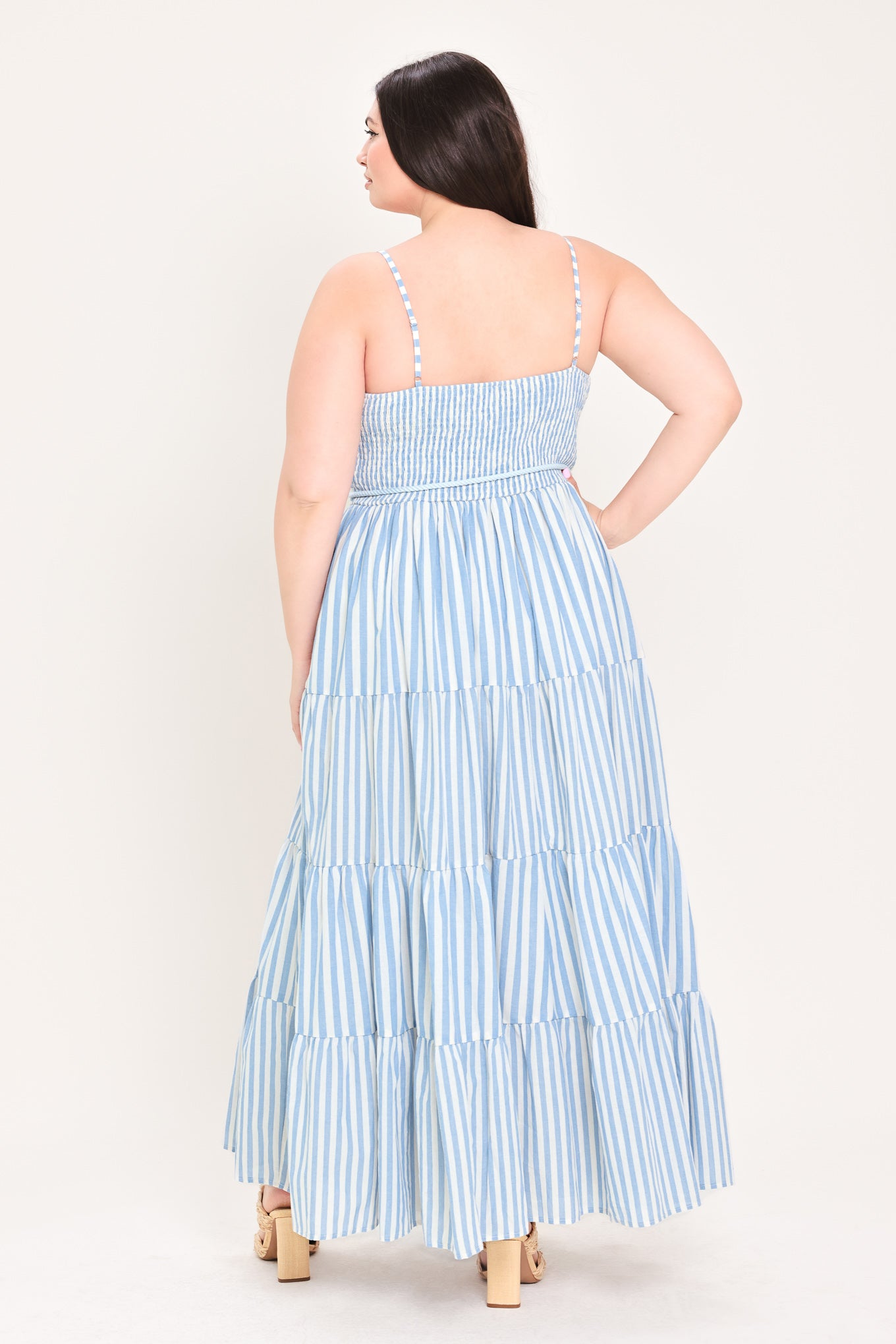 Woman wearing a blue and white striped maxi dress with a self tie belt | Flying Tomato Curve
