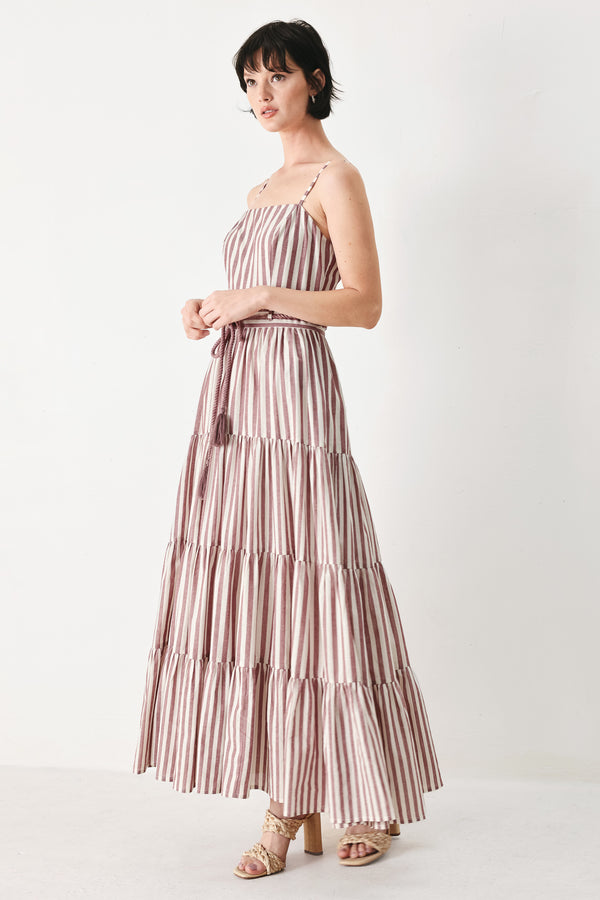 Woman wearing a burgundy striped woven ankle dress featuring straight neckline, straps, rope tie, tier skirt and back zipper closure | FREEMARKET