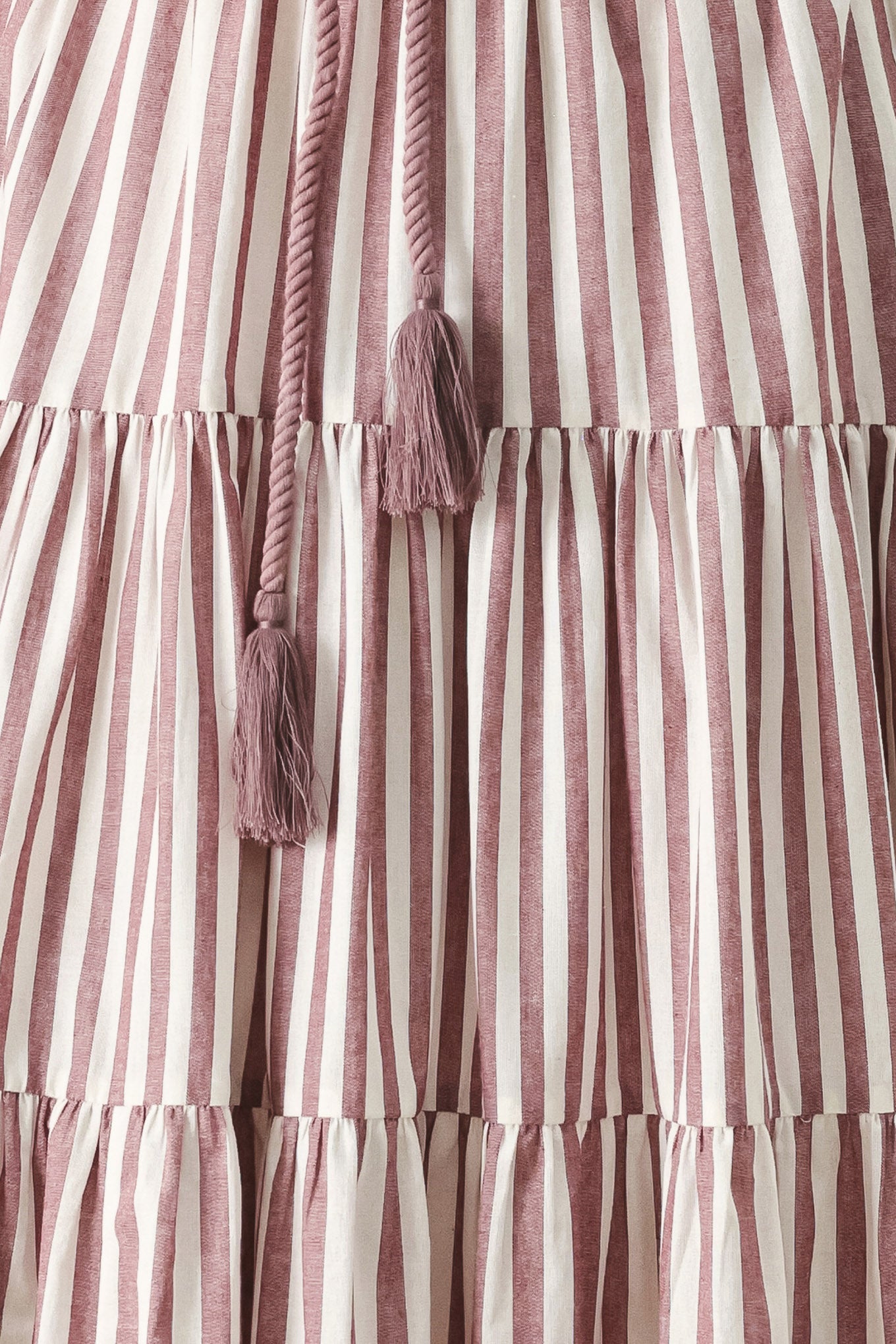 Close up of a burgundy striped woven ankle dress featuring straight neckline, straps, rope tie, tier skirt and back zipper closure | FREEMARKET