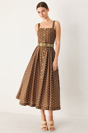 Woman wearing a brown with white polka dot midi dress featuring straight neckline, straps, button down detail, contrasting belt, full skirt and back zipper closure | FREEMARKET