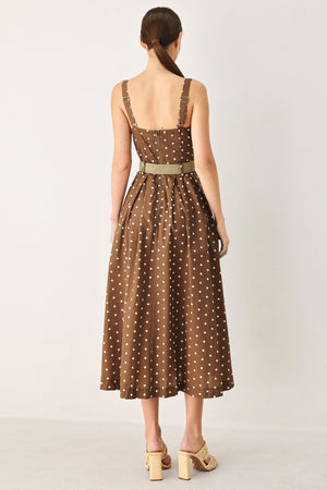 Woman wearing a brown with white polka dot midi dress featuring straight neckline, straps, button down detail, contrasting belt, full skirt and back zipper closure | FREEMARKET
