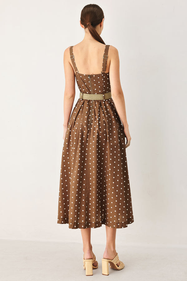 Woman wearing a brown with white polka dot midi dress featuring straight neckline, straps, button down detail, contrasting belt, full skirt and back zipper closure | FREEMARKET