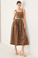 Woman wearing a brown with white polka dot midi dress featuring straight neckline, straps, button down detail, contrasting belt, full skirt and back zipper closure | FREEMARKET