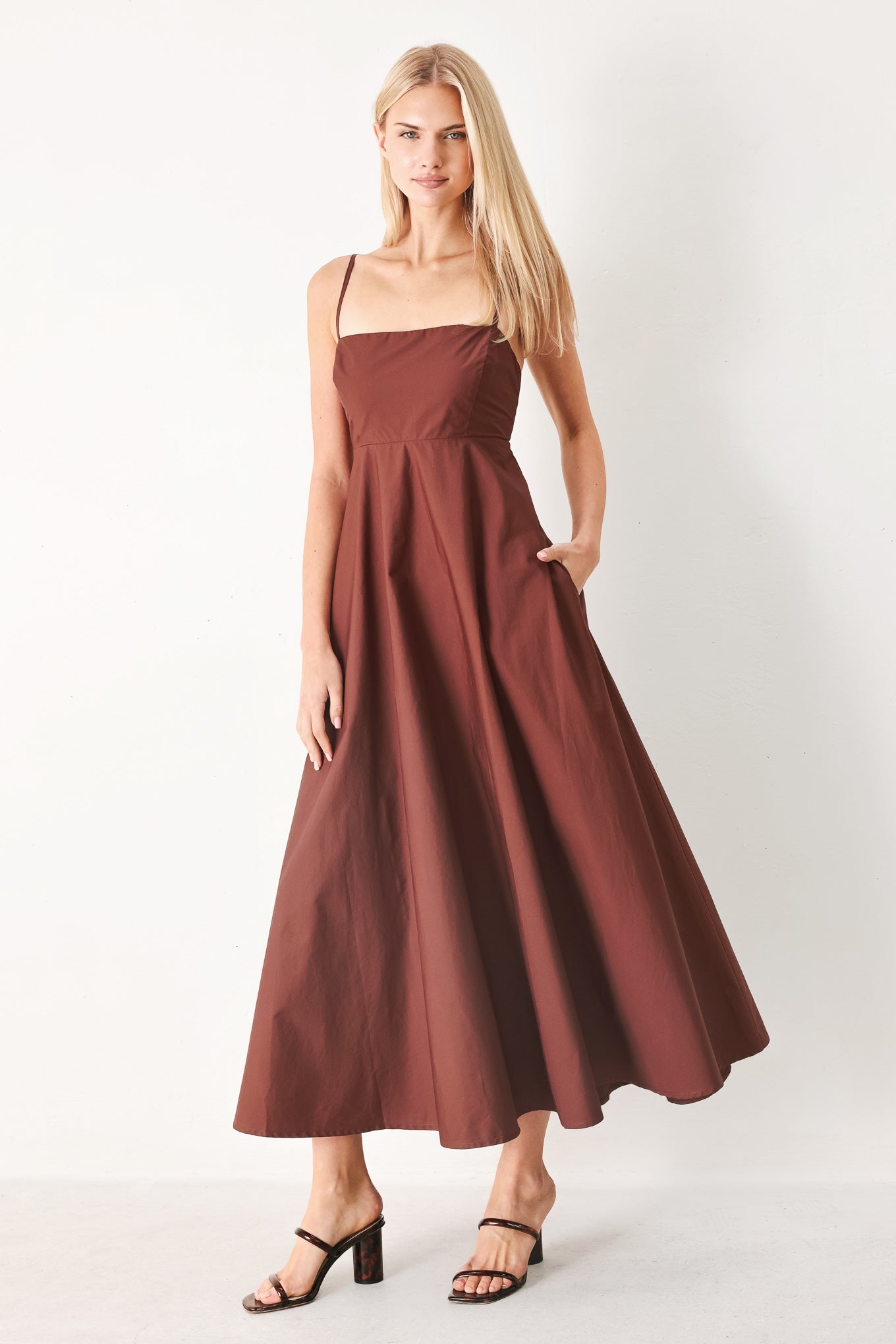 Woman wearing a dark rose midi dress featuring straight neckline, straps, circle skirt and back zipper closure | FREEMARKET