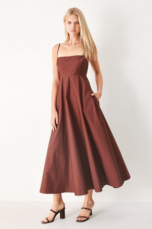 Woman wearing a dark rose midi dress featuring straight neckline, straps, circle skirt and back zipper closure | FREEMARKET