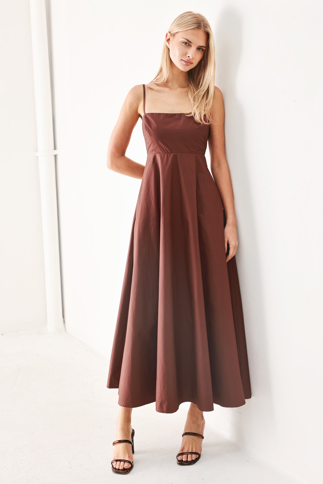 Woman wearing a dark rose midi dress featuring straight neckline, straps, circle skirt and back zipper closure | FREEMARKET