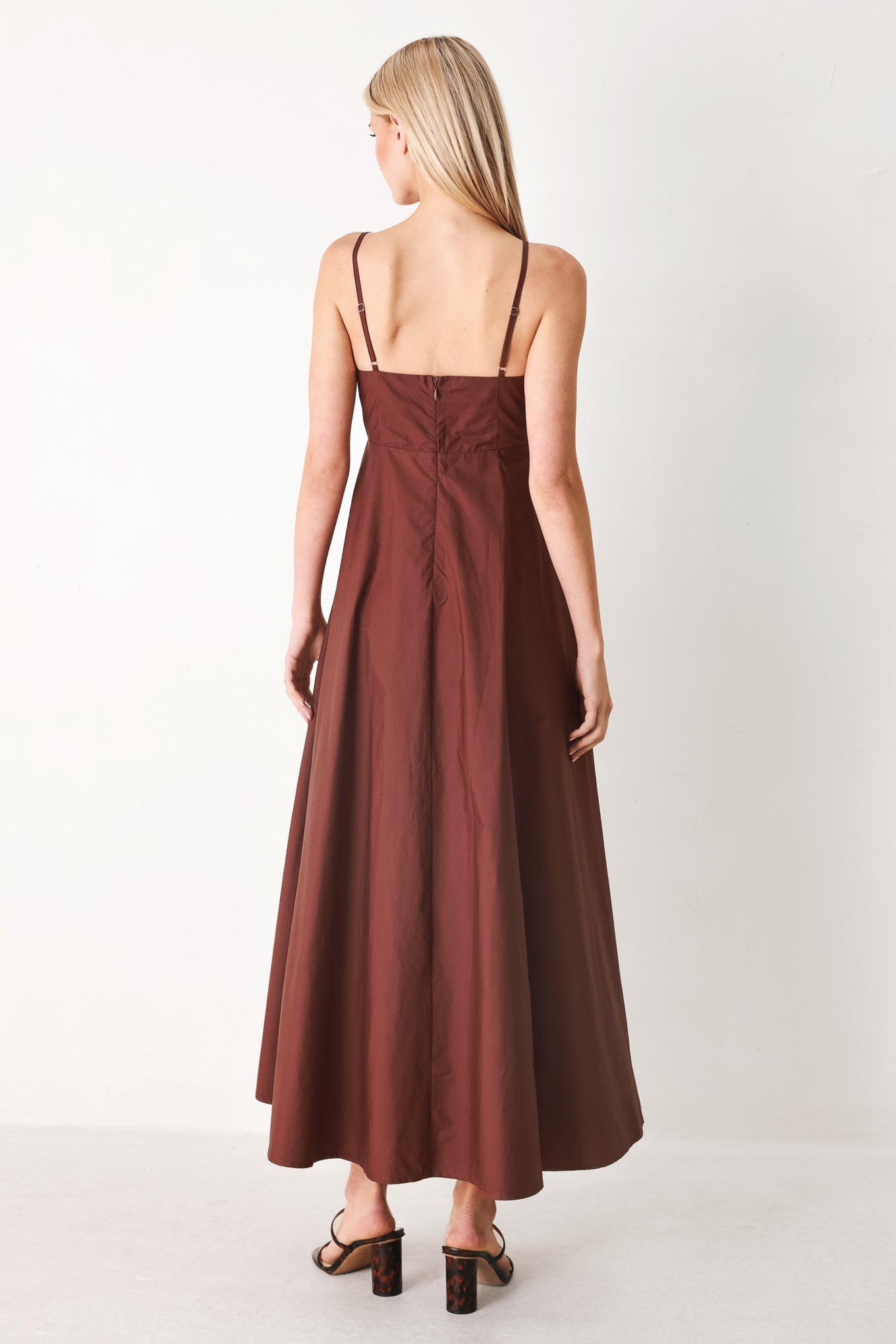 Woman wearing a dark rose midi dress featuring straight neckline, straps, circle skirt and back zipper closure | FREEMARKET