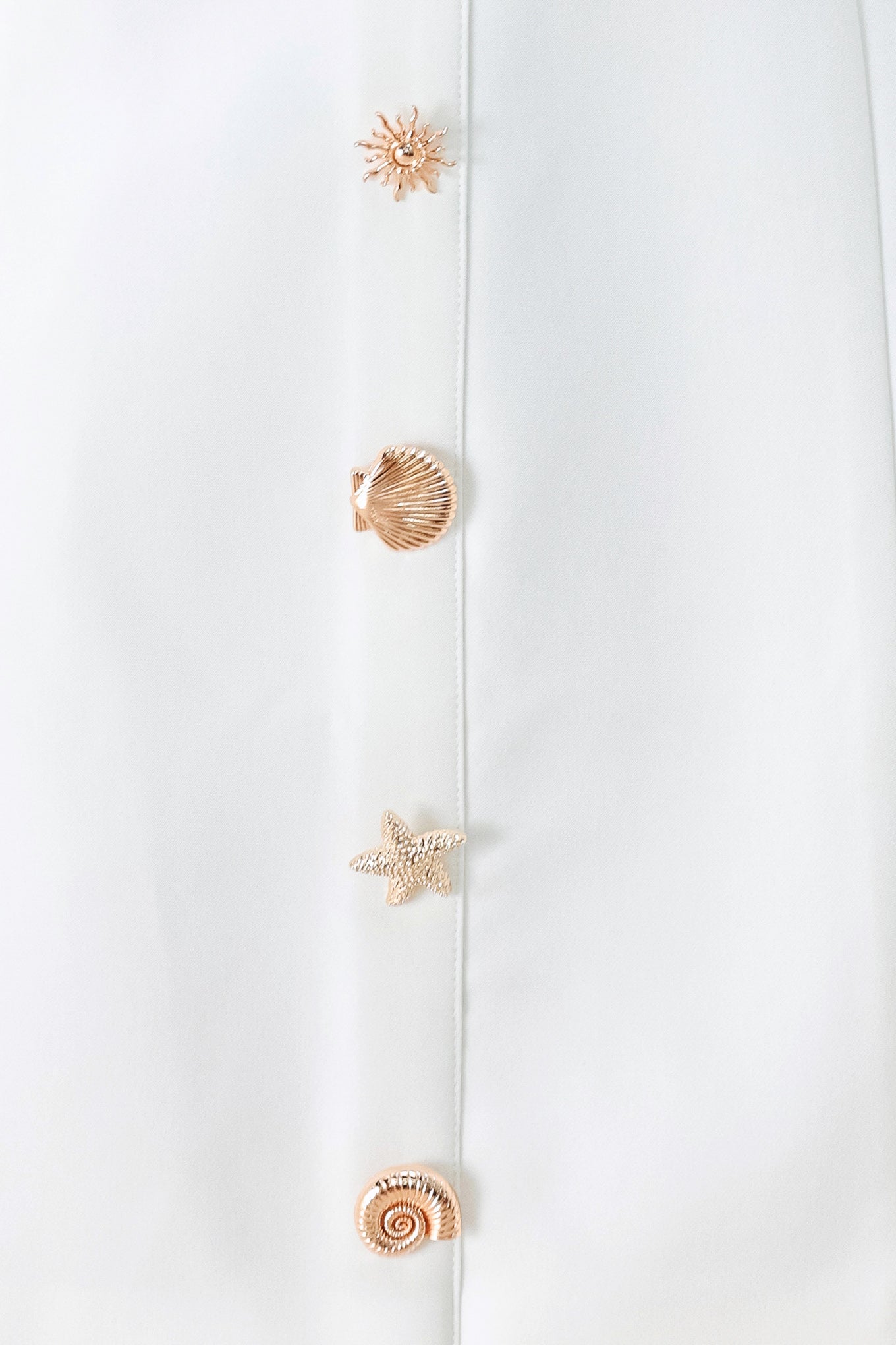 A solid woven mini dress featuring V neckline, sleeveless, button detail and back zipper closure