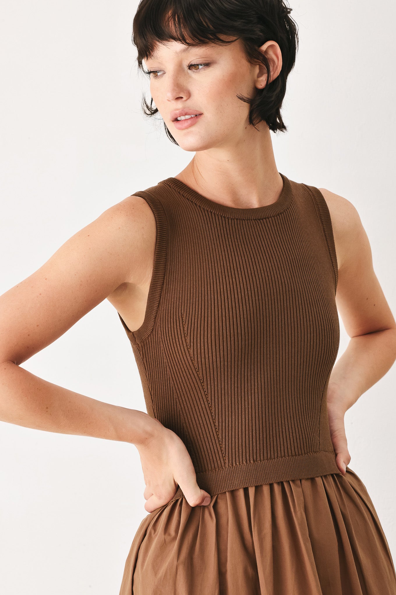 Woman wearing a brown sleeveless  sweater knit and woven mix midi dress featuring round neckline and tier skirt | FREEMARKET