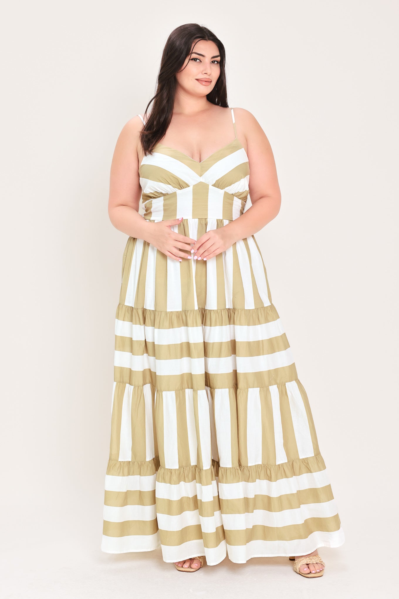 Woman wearing a taupe and white striped maxi dress | FREEMARKET Curve