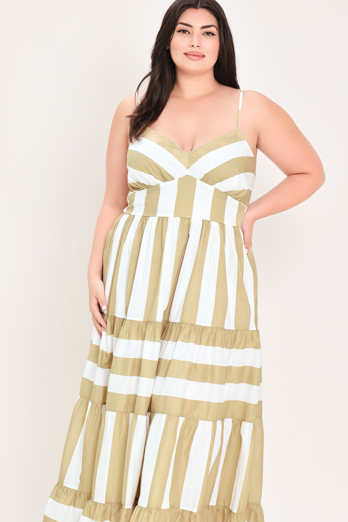 Woman wearing a taupe and white striped maxi dress | FREEMARKET Curve