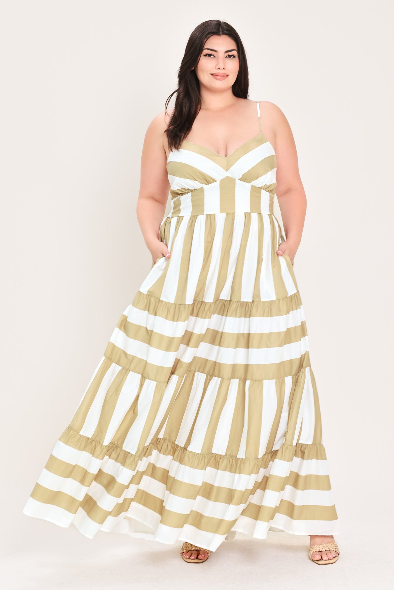 Woman wearing a taupe and white striped maxi dress | FREEMARKET Curve