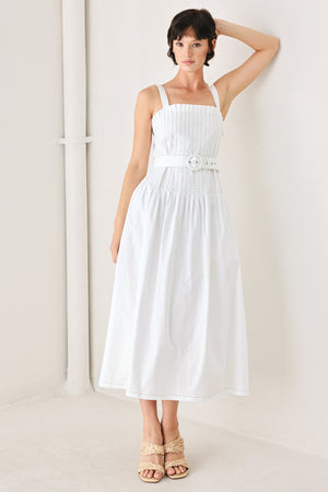 Woman wearing a white midi dress featuring straight neckline, straps, pintuck bodice, self belt and side zipper closure | FREEMARKET
