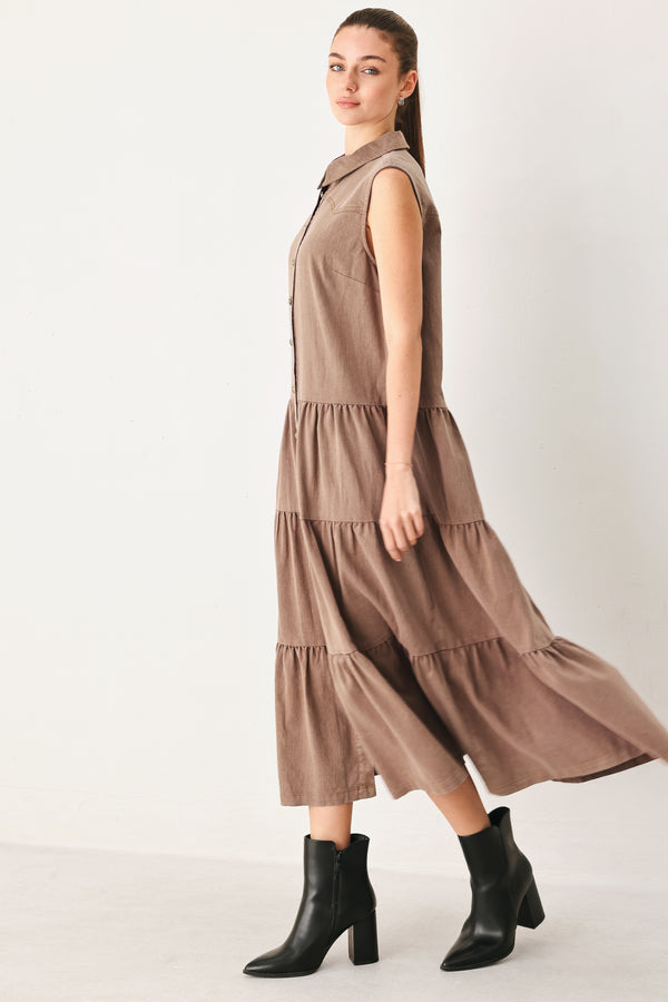 Woman wearing a sleeveless brown tiered midi dress featuring collar, button down, self tie and tier skirt | FREEMARKET