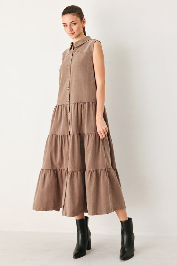 Woman wearing a sleeveless brown tiered midi dress featuring collar, button down, self tie and tier skirt | FREEMARKET
