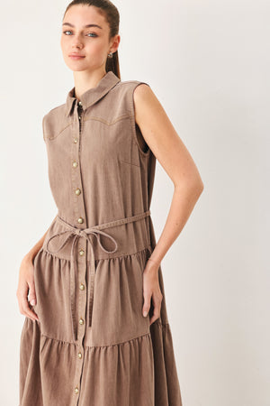 Woman wearing a sleeveless brown tiered midi dress featuring collar, button down, self tie and tier skirt | FREEMARKET
