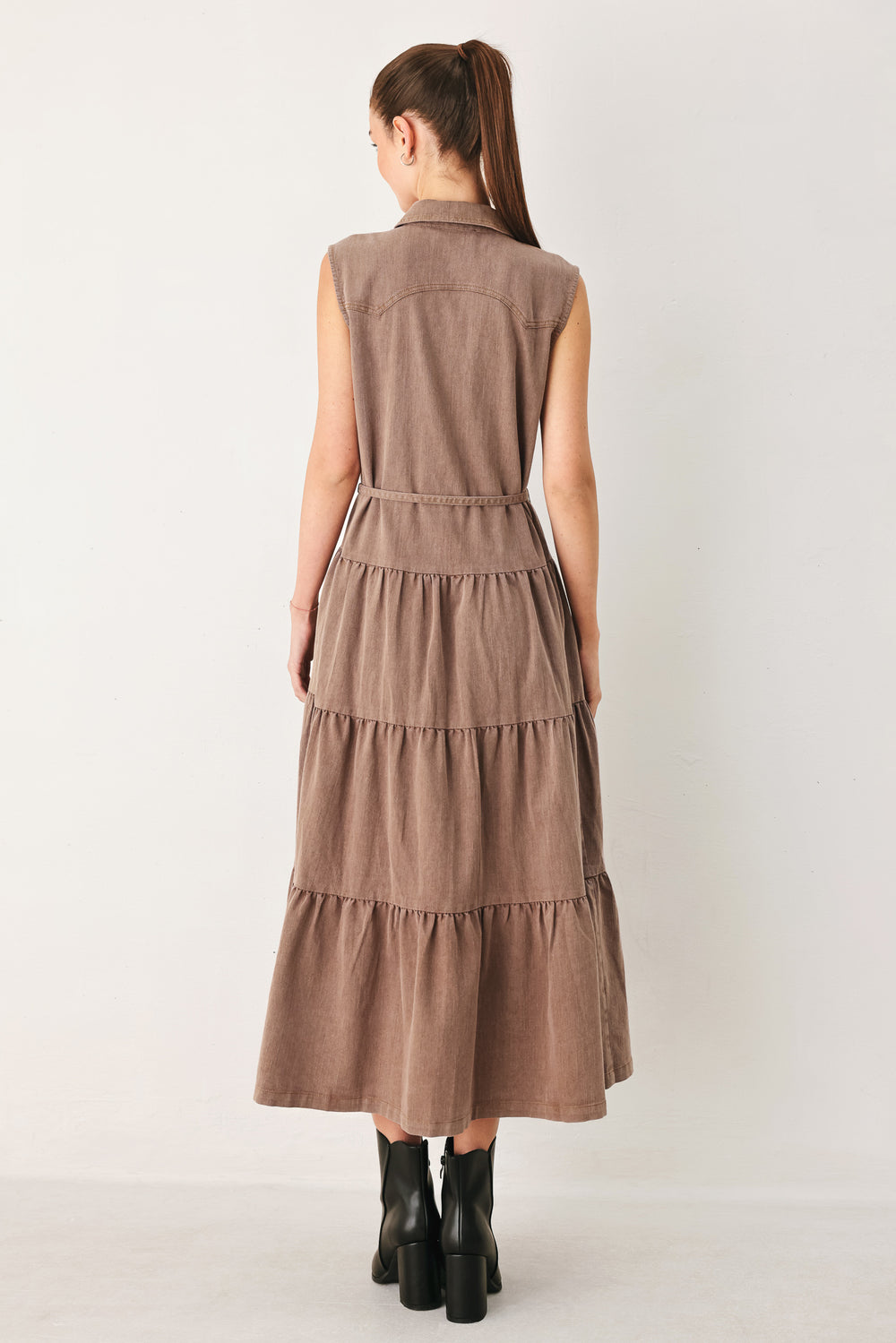 Woman wearing a sleeveless brown tiered midi dress featuring collar, button down, self tie and tier skirt | FREEMARKET
