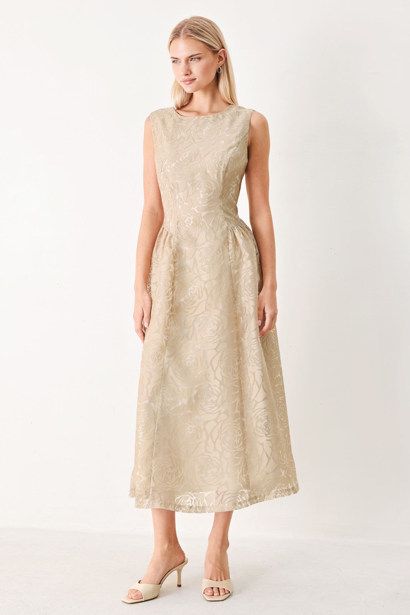 Woman wearing a beige lace burnout organza midi dress featuring round neckline, sleeveless, side shirring detail and back zipper closure | FREEMARKET