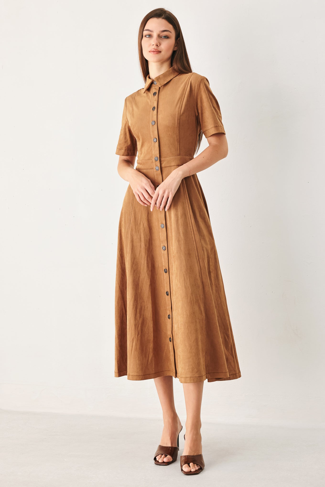 Woman wearing a camel brown faux suede midi shirt dress with short sleeve, front button down and circle skirt | FREEMARKET