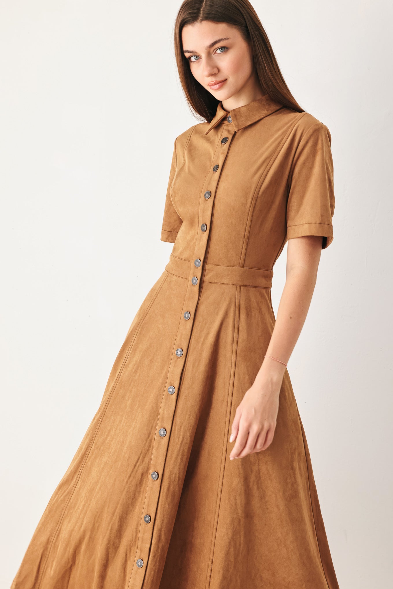 Woman wearing a camel brown faux suede midi shirt dress with short sleeve, front button down and circle skirt | FREEMARKET