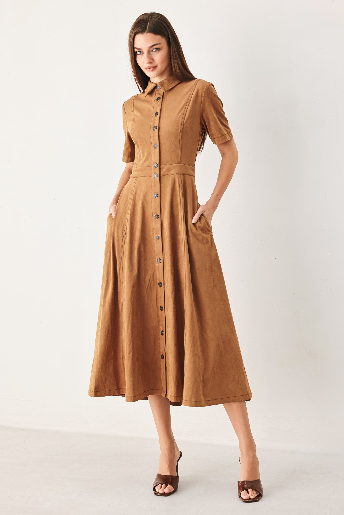 Woman wearing a camel brown faux suede midi shirt dress with short sleeve, front button down and circle skirt | FREEMARKET