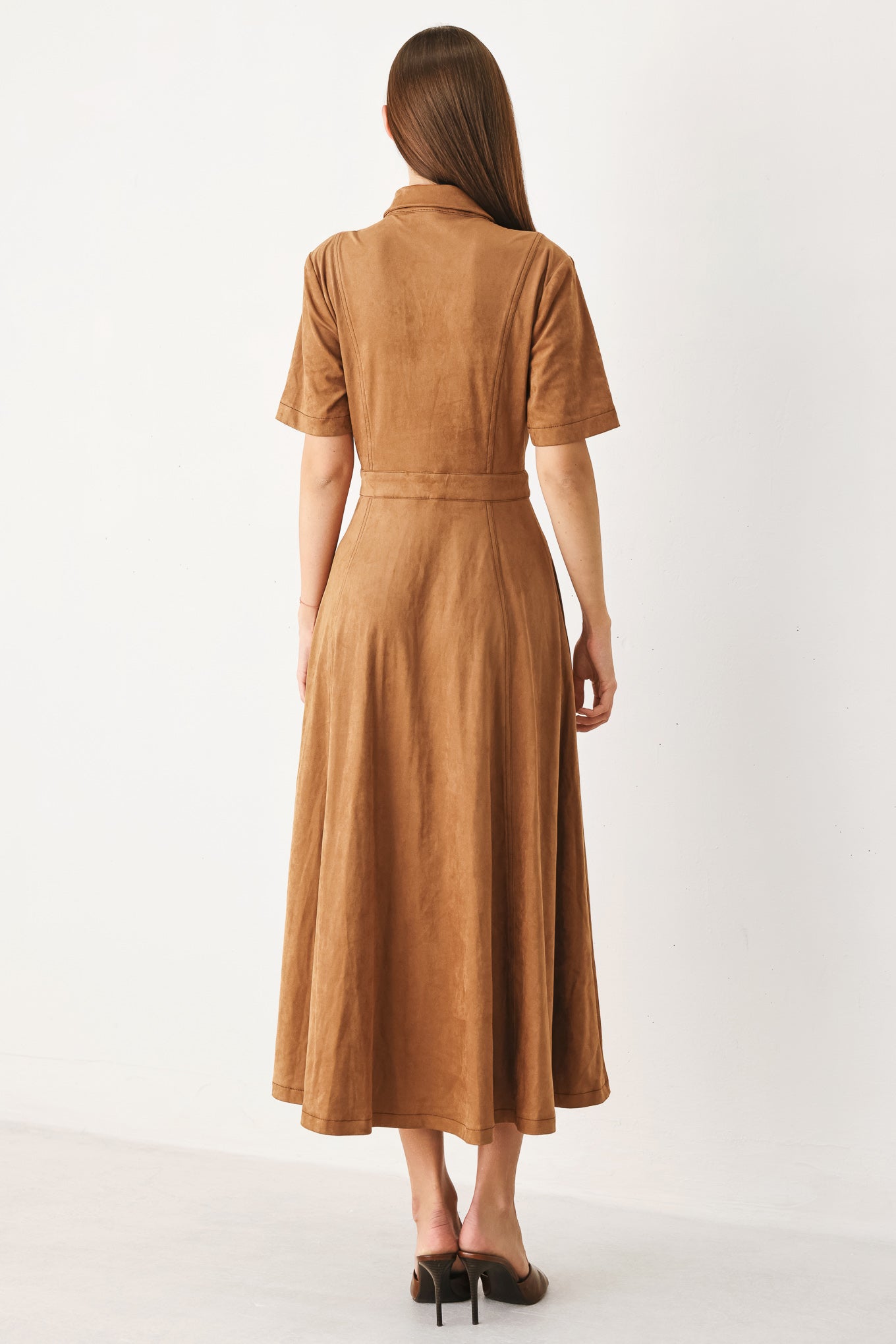 Woman wearing a camel brown faux suede midi shirt dress with short sleeve, front button down and circle skirt | FREEMARKET