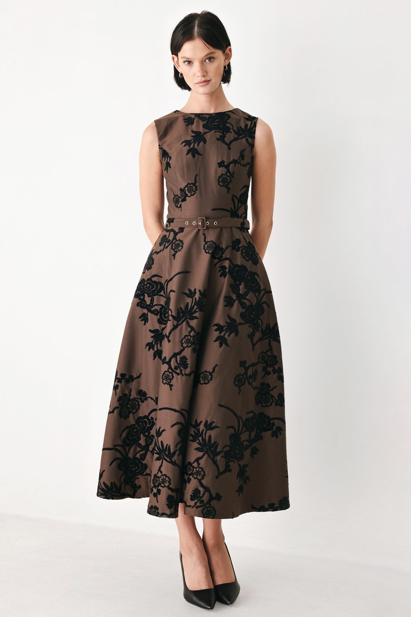 A sleeveless brown midi dress with a black floral brocade pattern, featuring a structured bodice, a matching fabric belt with a small metallic buckle, and a flared skirt | FREEMARKET