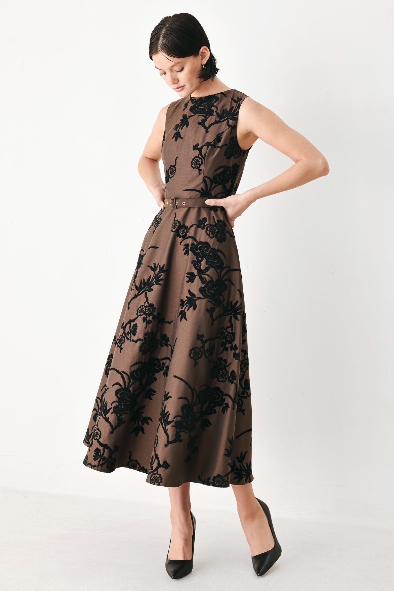 A sleeveless brown midi dress with a black floral brocade pattern, featuring a structured bodice, a matching fabric belt with a small metallic buckle, and a flared skirt | FREEMARKET