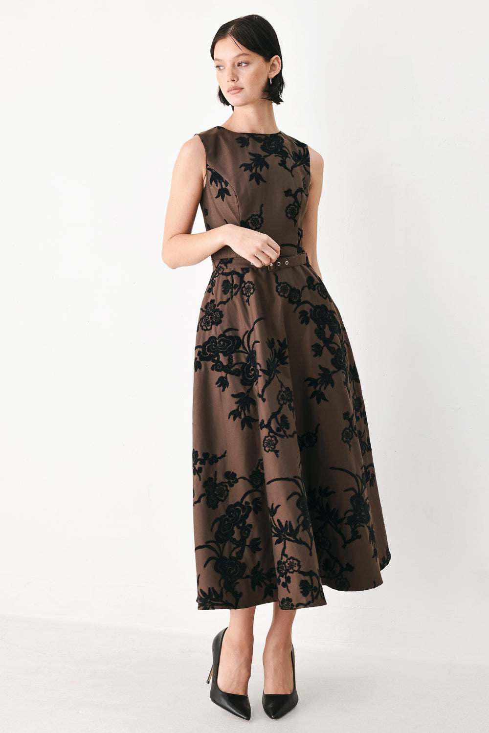 A sleeveless brown midi dress with a black floral brocade pattern, featuring a structured bodice, a matching fabric belt with a small metallic buckle, and a flared skirt | FREEMARKET