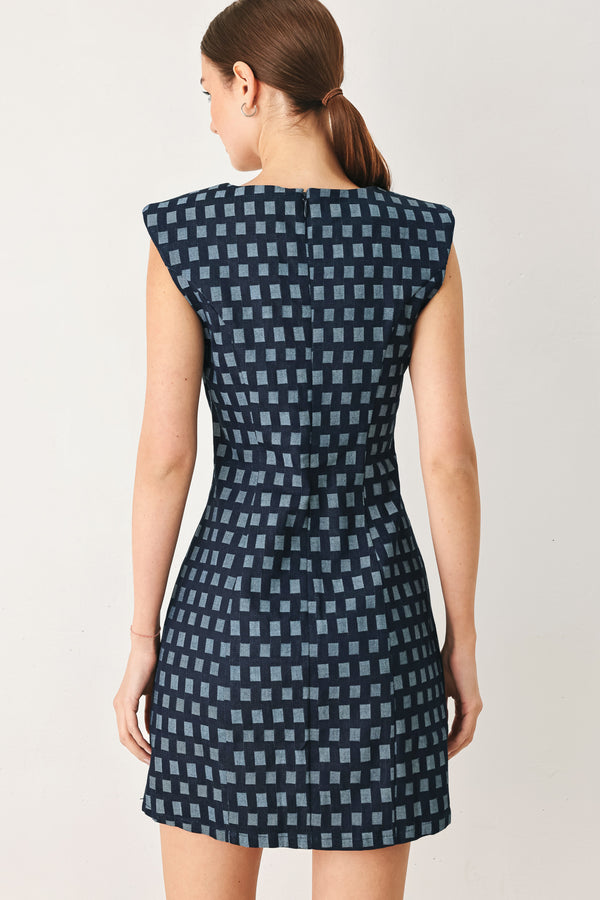 Woman wearing a denim navy patterned jacquard denim mini dress with round neckline, sleeveless and back zipper closure | Flying Tomato