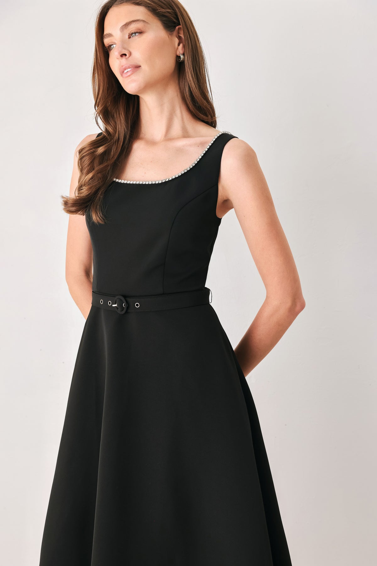 Woman wearing a black u-neckline with embellishments midi dress and matching thin waist belt | Flying Tomato