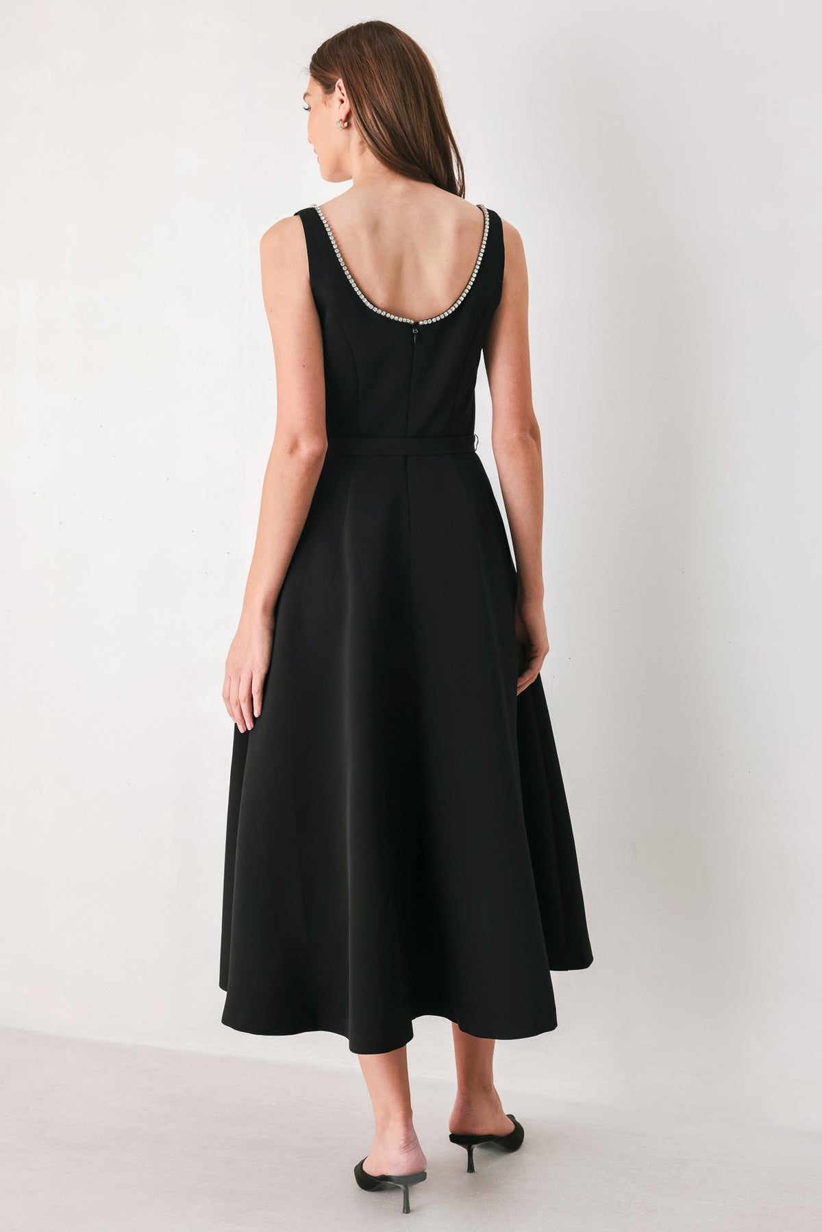 Woman wearing a black u-neckline with embellishments midi dress and matching thin waist belt | Flying Tomato