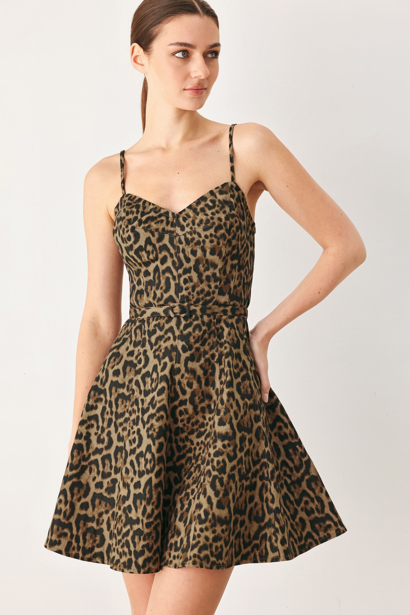 Woman wearing a leopard printed woven mini dress featuring bustier top, straps, self belt, circle skirt and back zipper closure | FREEMARKET