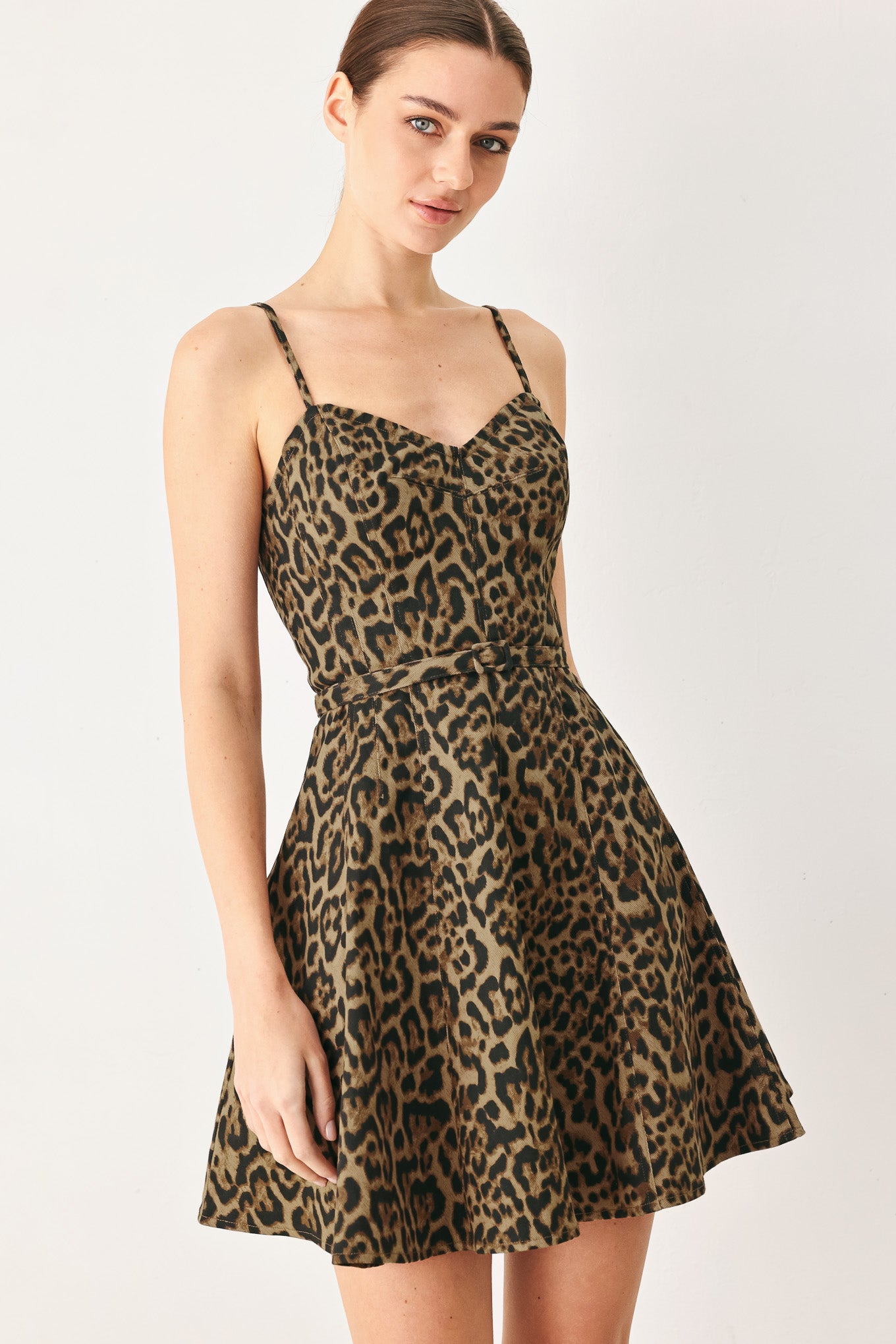 Woman wearing a leopard printed woven mini dress featuring bustier top, straps, self belt, circle skirt and back zipper closure | FREEMARKET