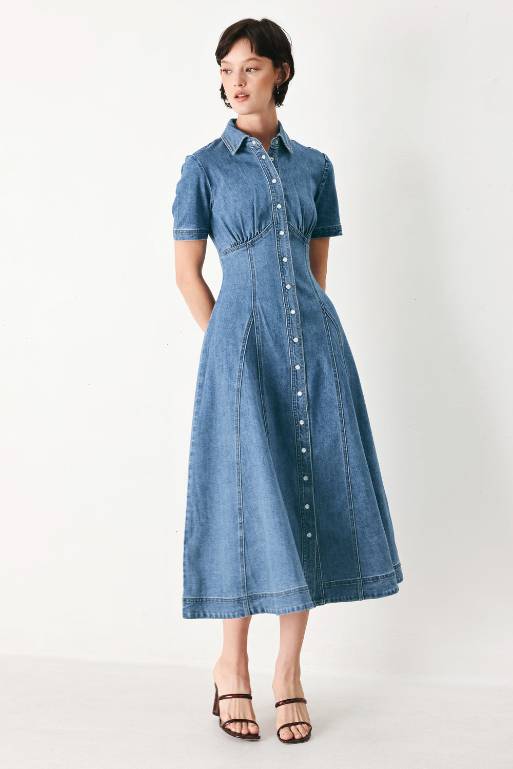Woman wearing a blue denim midi shirt dress with front closure and circle skirt | FREEMARKET