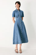 Woman wearing a blue denim midi shirt dress with front closure and circle skirt | FREEMARKET