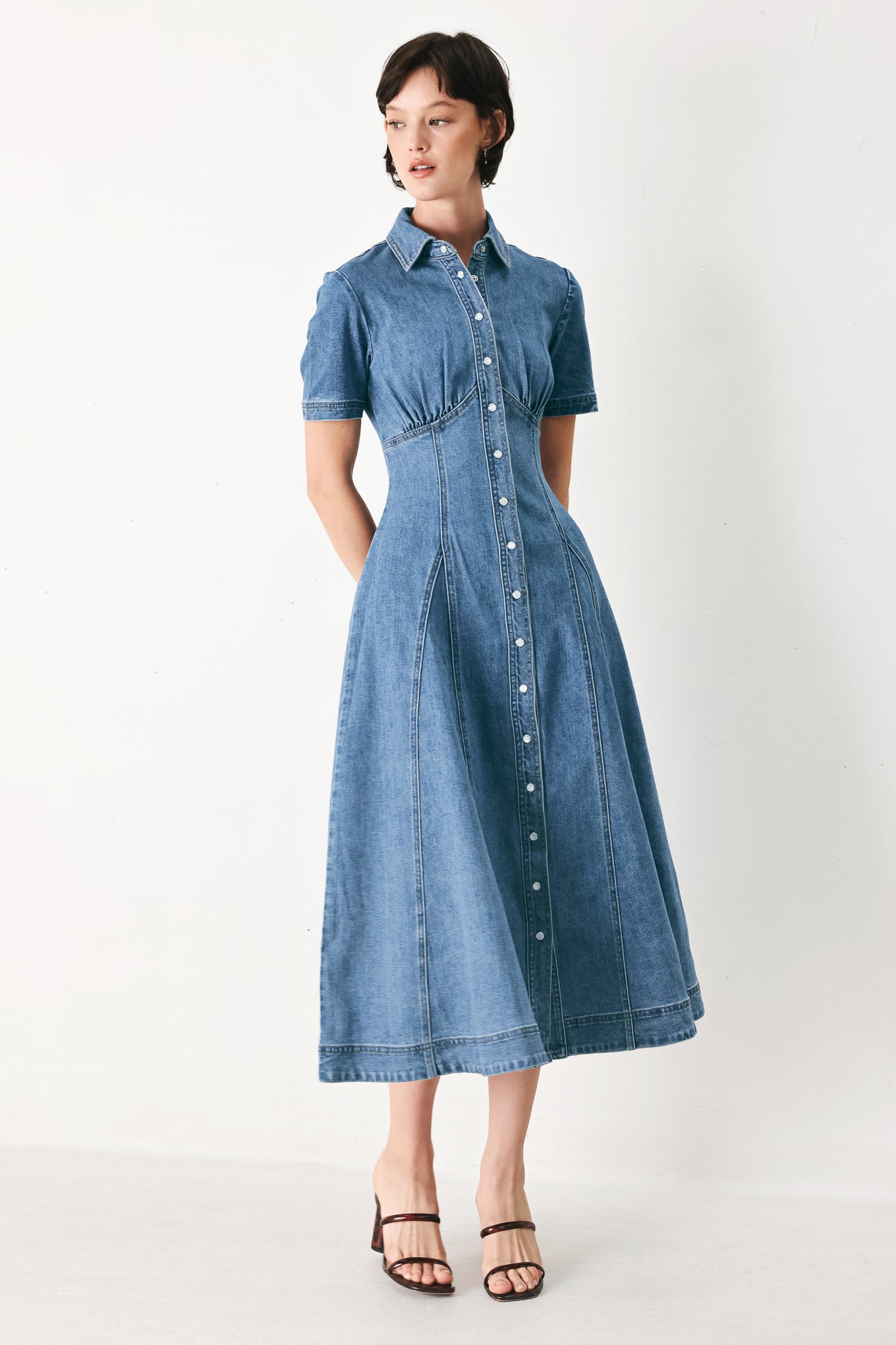 Woman wearing a blue denim midi shirt dress with front closure and circle skirt | FREEMARKET