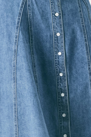Woman wearing a blue denim midi shirt dress with front closure and circle skirt | FREEMARKET