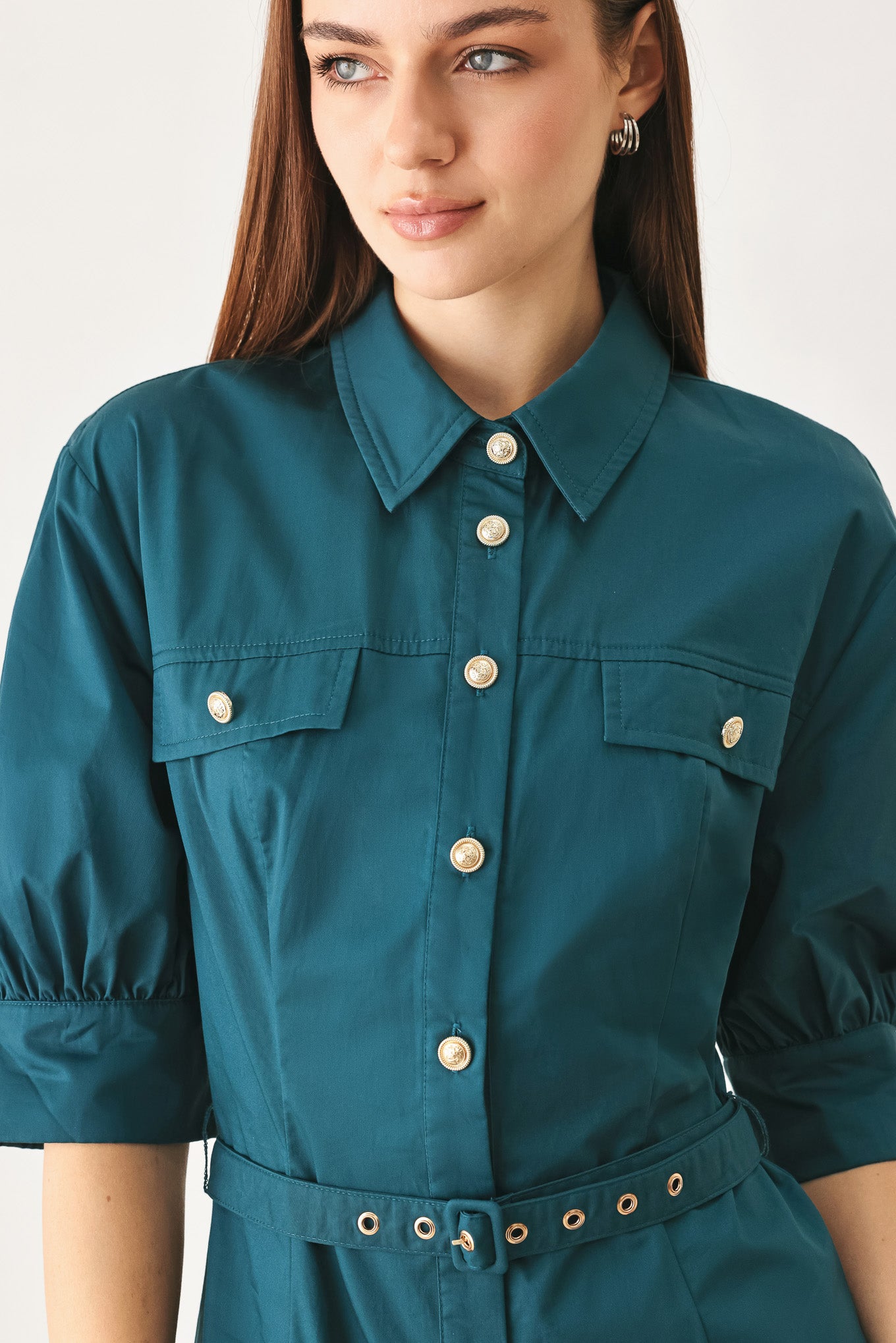 Woman wearing a teal blue midi dress featuring collar, elbow sleeve, front button down, self belt and circle skirt | FREEMARKET