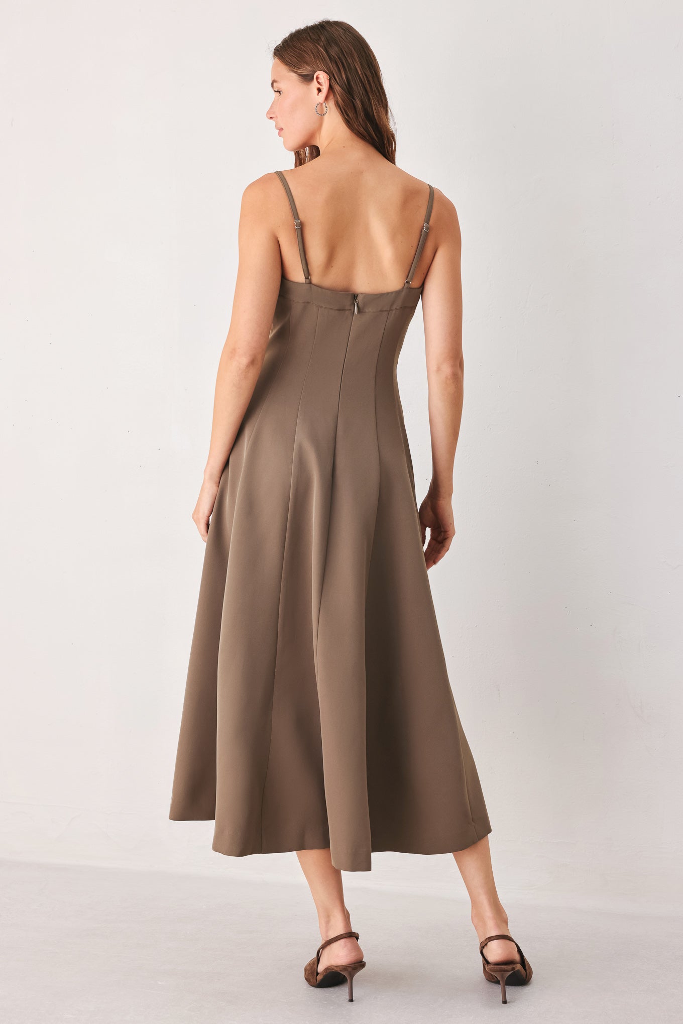 A woman wearing a sleeveless midi dress in a muted mocha-brown color | FREEMARKET
