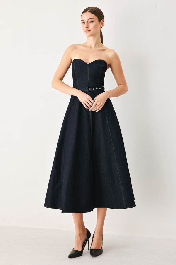 Woman wearing a dark denim strapless midi dress featuring a sweetheart neckline, self belt, circle skirt and back zipper closure | FREEMARKET