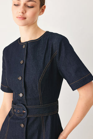 Woman wearing a navy dark denim midi dress with buttons and waist belt | FREEMARKET