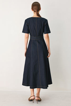 Woman wearing a navy dark denim midi dress with buttons and waist belt | FREEMARKET