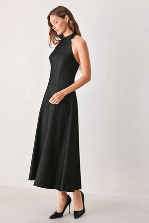 A woman modeling a sleeveless black midi dress with a high mock neck and flared skirt | FREEMARKET